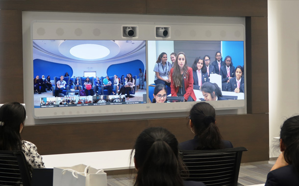 Girls engaging with Cisco Executives using Cisco’s telepresence