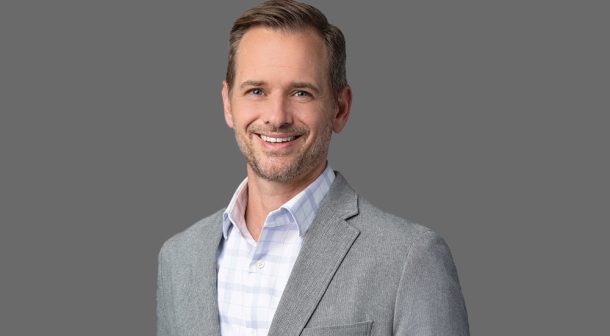 Ric Smith smiling in a light grey blazer – President of Product, Technology, and Operations at SentinelOne