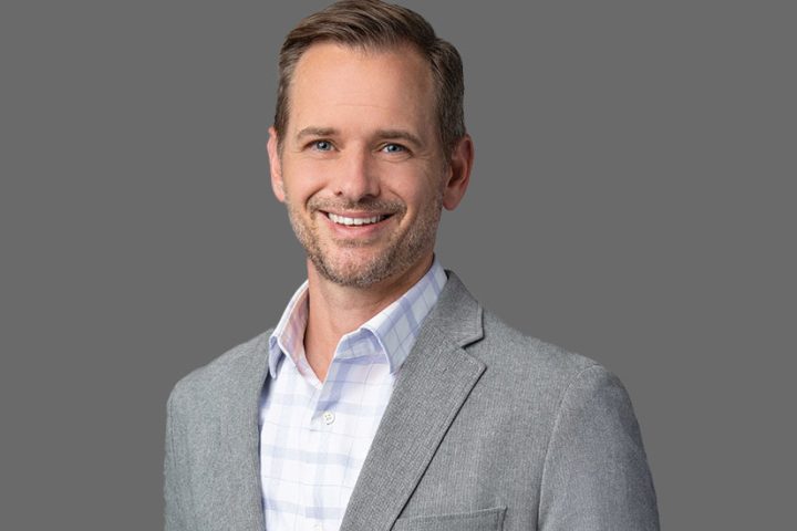 Ric Smith smiling in a light grey blazer – President of Product, Technology, and Operations at SentinelOne
